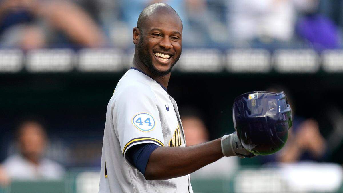 Milwaukee Brewers’ Lorenzo Cain aknowledges the crowd’s applause as he comes up to bat during the first inning of a baseball game against the Kansas City Royals Tuesday, May 18, 2021, in Kansas City, Mo. Cain is a former Royals player. (AP Photo/Charlie Riedel)