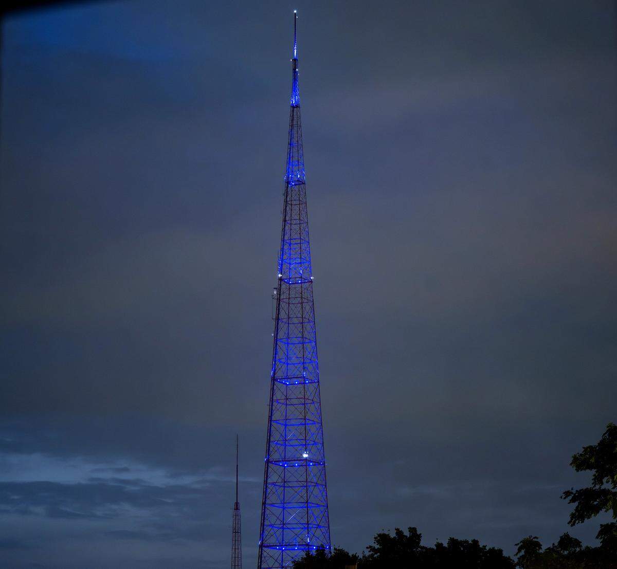 KCTV broadcast tower illuminates in a blue hue during a lighting test on Tuesday, Sept. 9, 2025, in Kansas City.