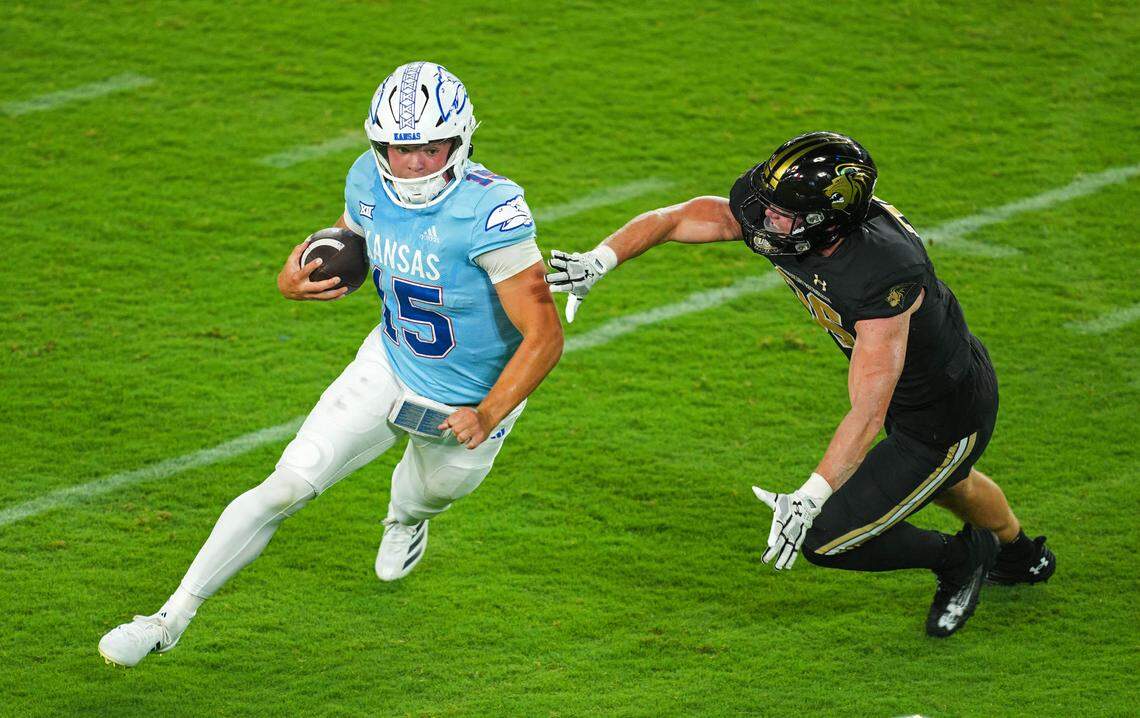 Kansas Jayhawks quarterback Cole Ballard (15) runs the ball against Lindenwood Lions linebacker Jacob Waller (36) during the second half at Children’s Mercy Park on Aug. 29, 2024.