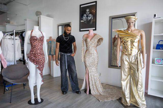 Sheraz Pompey stands amongst mannequins wearing a few of his designs at The Blueprint KC.