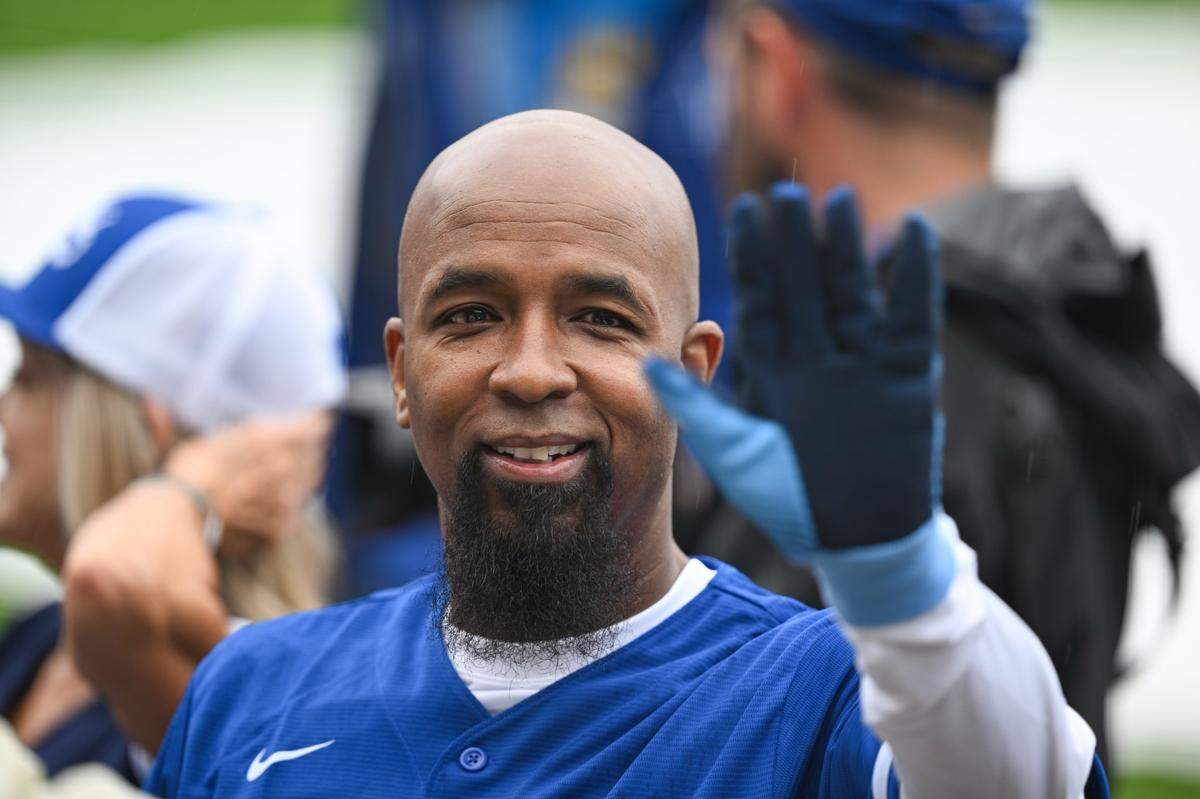 Kansas City hip-hop star Tech N9ne waves to the crowd at Kauffman Stadium before the Friday’s Big Slick Celebrity Softball Game.