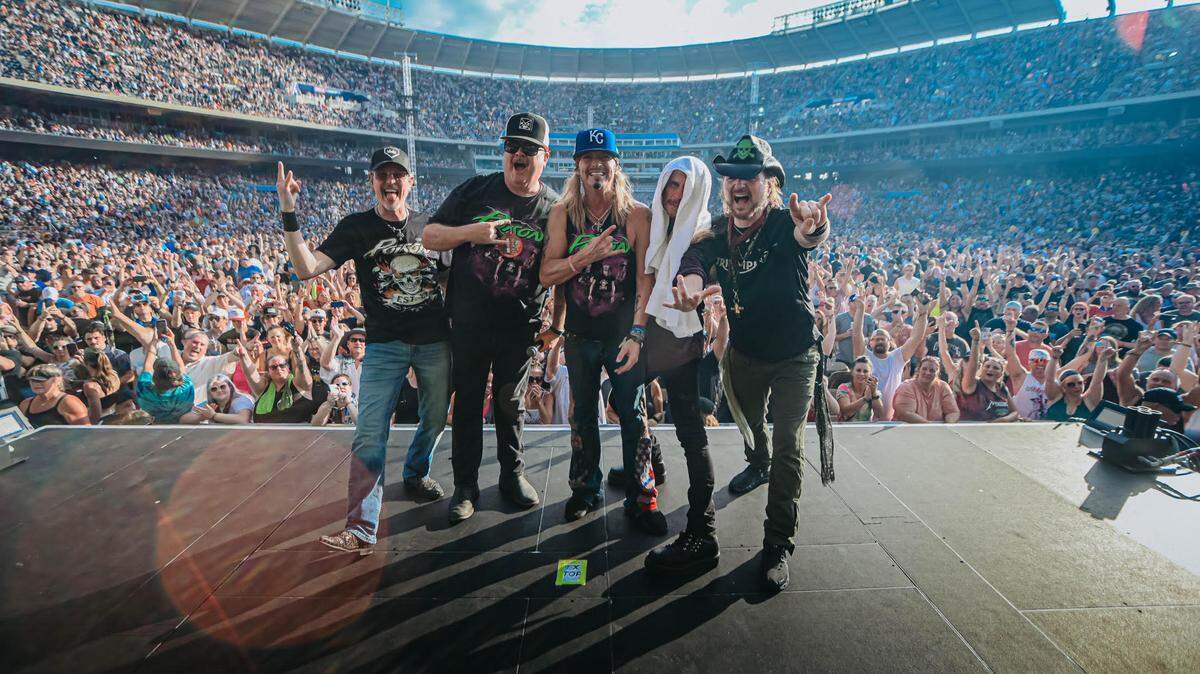 Eric Stonestreet, second from left, joined the band Poison on stage at Tuesday’s concert at Kauffman Stadium.