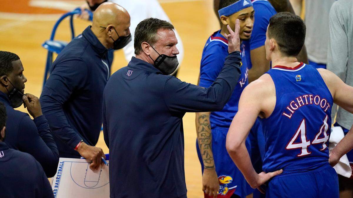 Kansas head coach Bill Self, center, talks to his team during a timeout in the first half of an NCAA college basketball game against Texas, Tuesday, Feb. 23, 2021, in Austin, Texas. (AP Photo/Eric Gay)