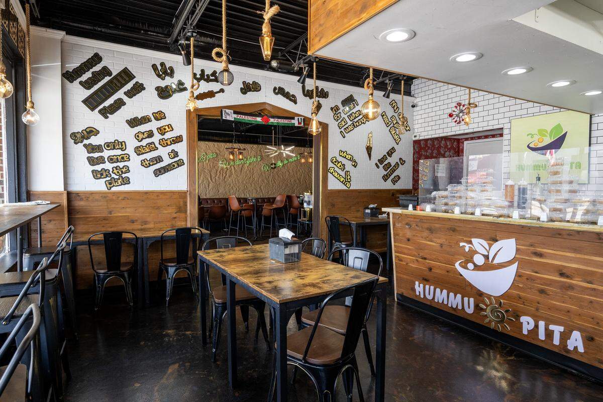 Decorative phrases adorn a wall near the main entrance at Hummus and Pita on Tuesday, Sept. 2, 2025, in Overland Park.