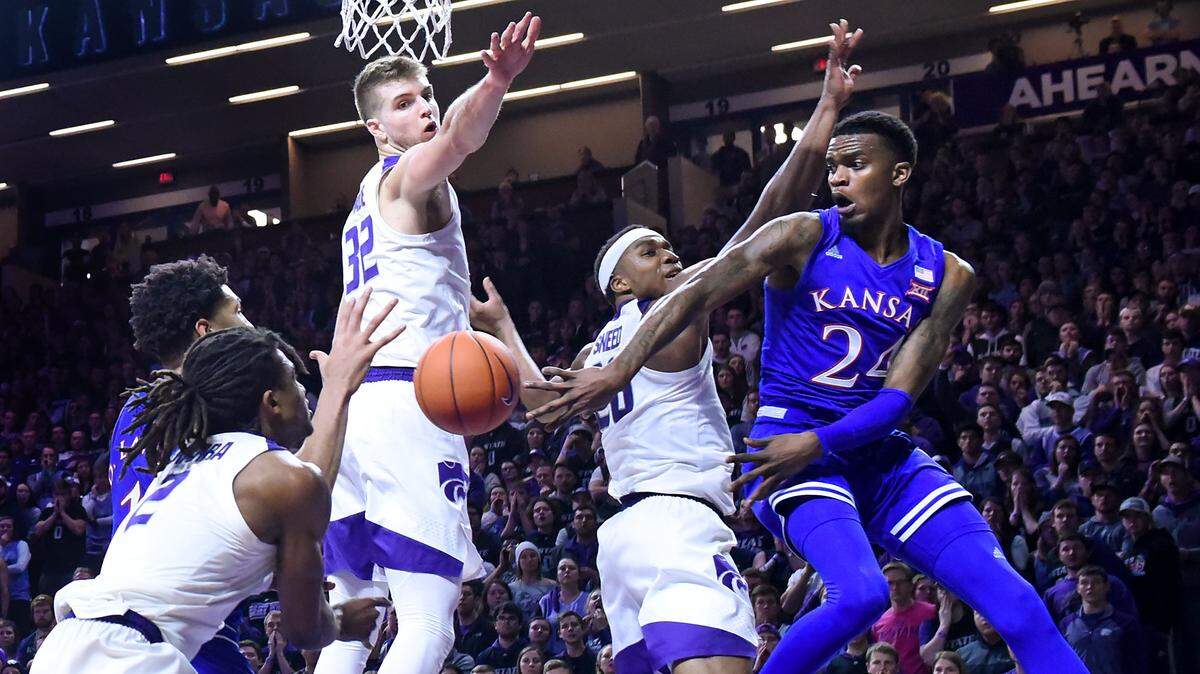Then playing for Kansas, Lagerald Vick whips a pass around K-State’s Xavier Sneed and Dean Wade during a 2019 Big 12 game at Bramlage Coliseum in Manhattan.