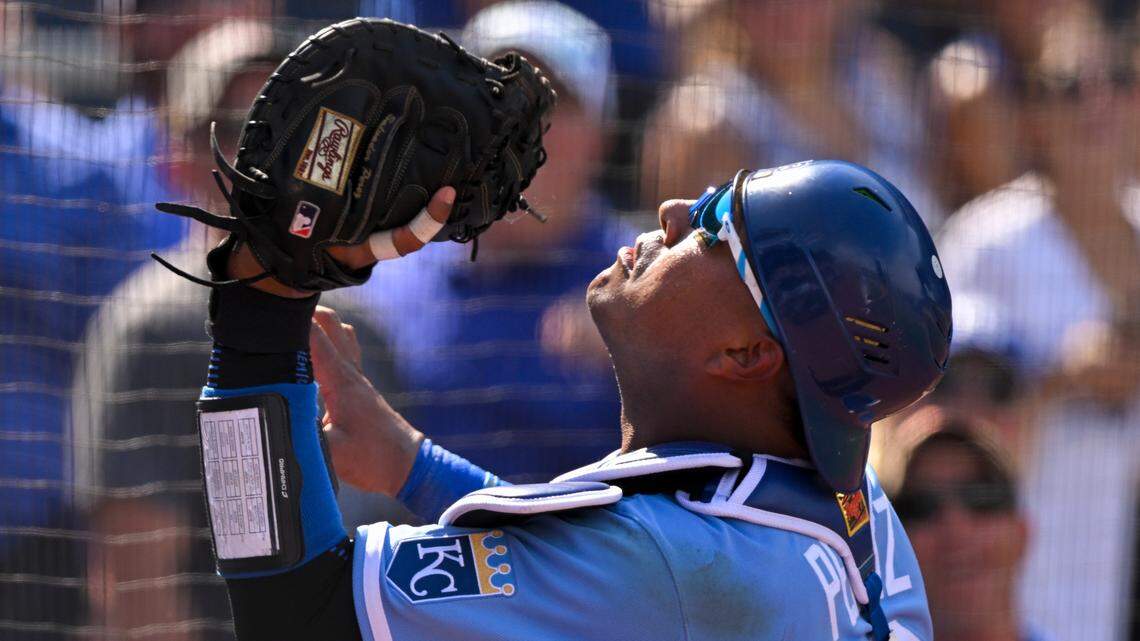 Kansas City Royals catcher Salvador Perez goes into the netting to catch a pop fly off the bat of Los Angeles Dodgers’ Chris Taylor for the third out in the ninth inning of a baseball game, Sunday, Aug. 14, 2022, in Kansas City, Mo. (AP Photo/Reed Hoffmann)