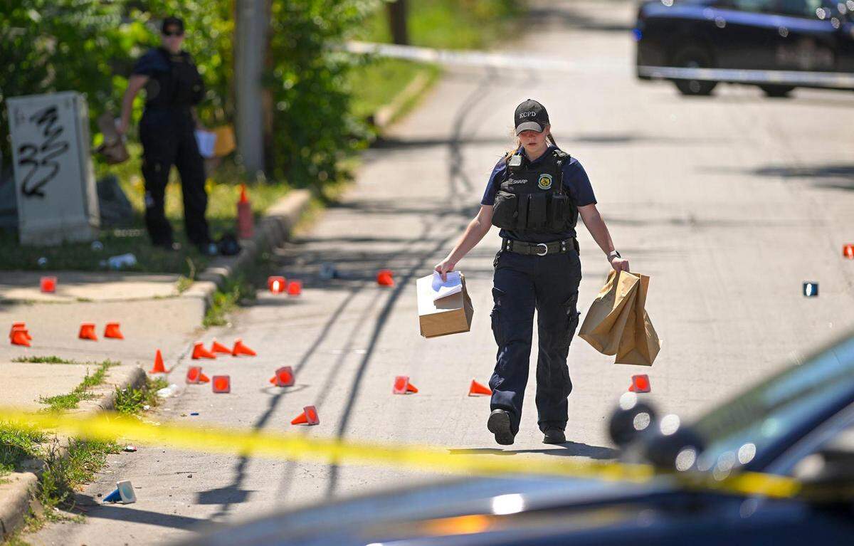 Police and crime scene investigators were on the scene collecting evidence where three people died and five were injured following a shooting early Sunday, June 25, 2023, near 57th Street and Prospect Avenue in Kansas City. Super Bowl KC Star