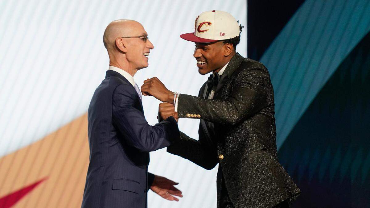 Ochai Agbaji embraces NBA Commissioner Adam Silver after being selected 14th overall by the Cleveland Cavaliers in the 2022 NBA Draft in New York.