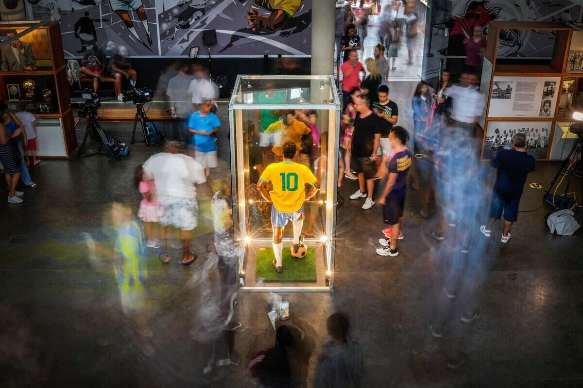 A statue of Pele in a bright-yellow No. 10 Brazil jersey is displayed in a glass case at the Pele Museum in Santos, Brazil. Pele died in a Sao Paulo hospital on Thursday at the age of 82.