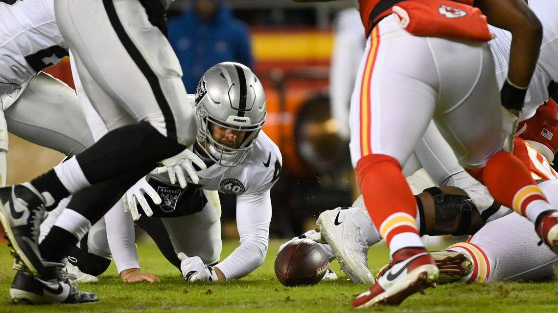 Oakland Raiders quarterback Derek Carr (4) tries to recover a fumble against the Kansas City Chiefs during the second half of an NFL football game in Kansas City, Mo., Sunday, Dec. 1, 2019. (AP Photo/Reed Hoffmann)