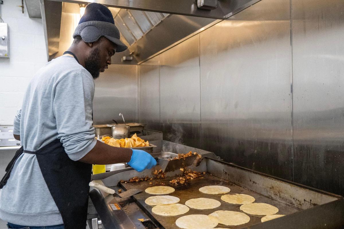 Jaunatan Liberice prepares an order in the commercial kitchen for LocoZilla on Thursday, Jan. 23, 2025, in Kansas City.