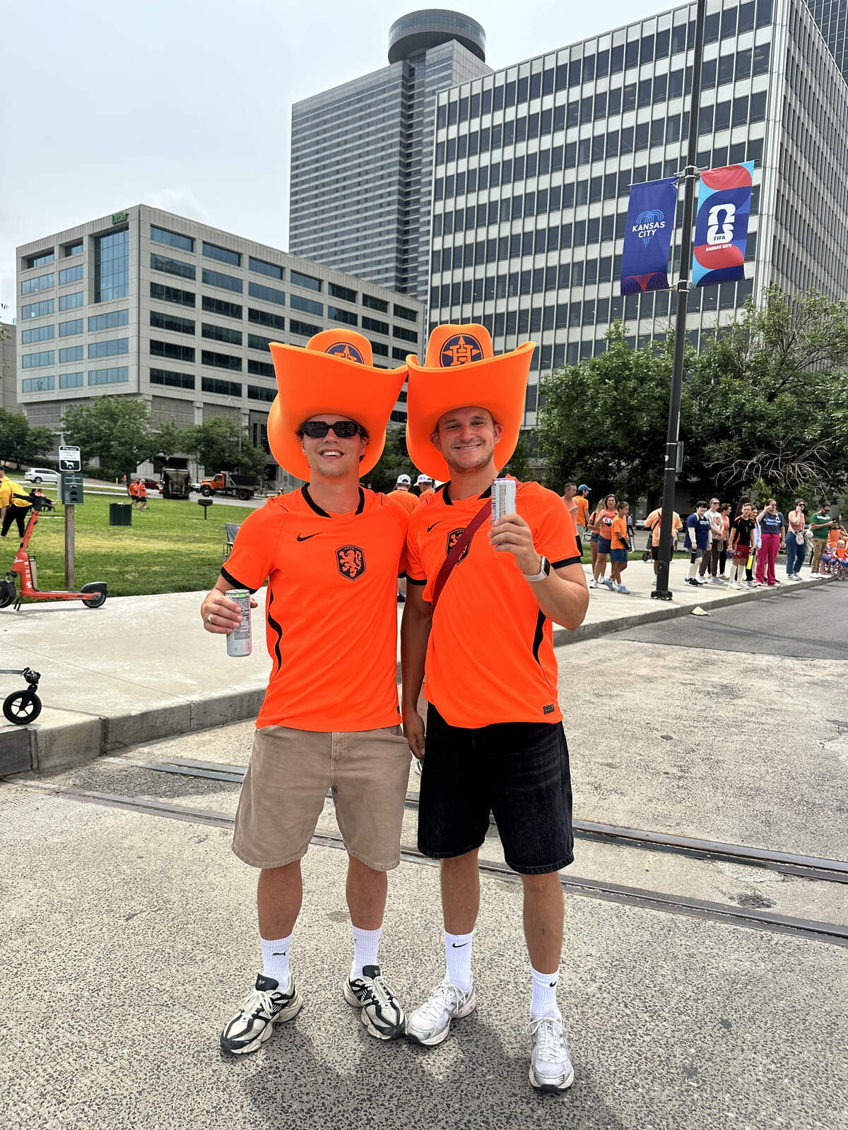 Justin De Jong and Stejn Berg pose together with large orange cowboy hats they bought in Texas. They traveled from Amsterdam to attend every Dutch match and the surrounding festivities.