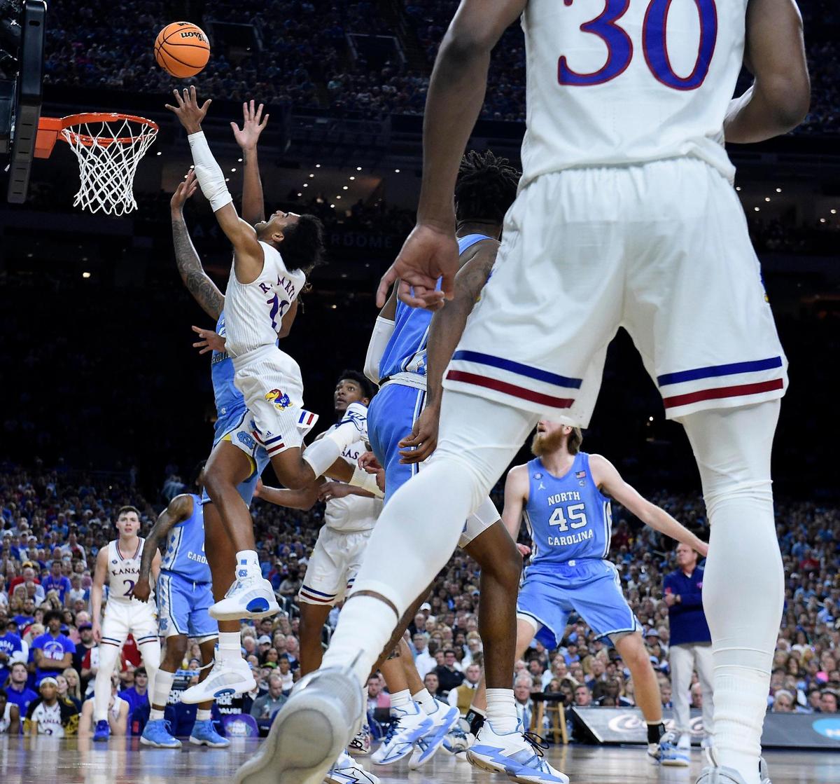 KU’s Remy Martin hit this late shot over UNC’s Caleb Love during the second half of Monday night’s NCAA championship game at the Superdome in New Orleans. KU beat North Carolina, 72-69.