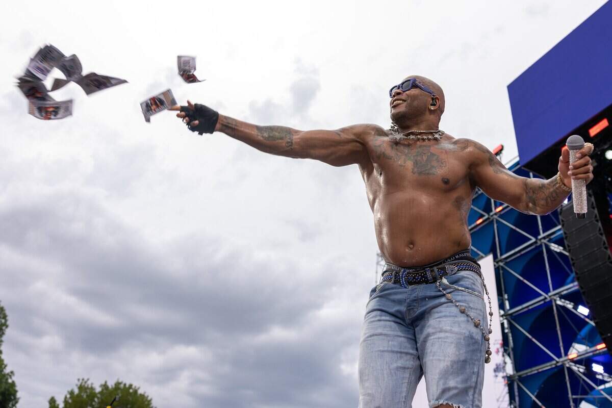 Flo Rida throws fake money out to the crowd during their FIFA Fan Fest concert at Fan Fest on Friday, June 19, 2026.