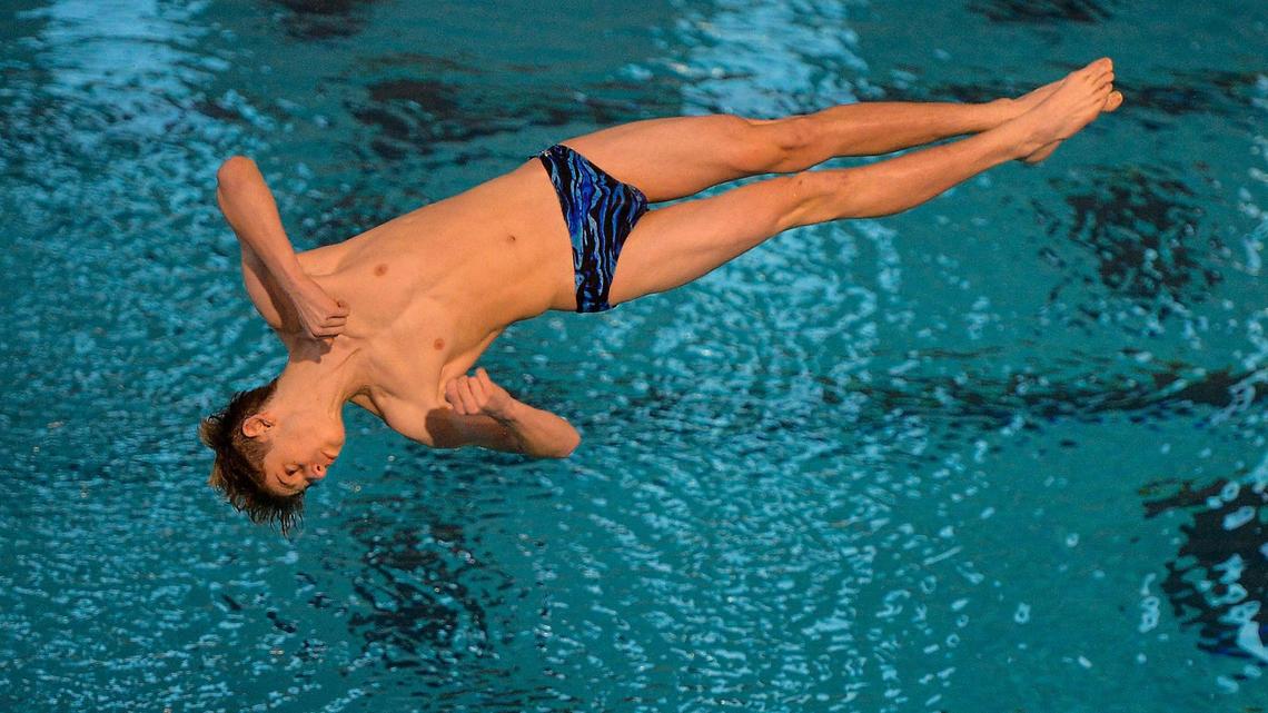 Shawnee Mission East sophomore Henry Cecil dives in the one-meter diving competition Friday, February 19, 2021, at the 6A Kansas Boys State Swimming and Diving Championships in Lenexa.
