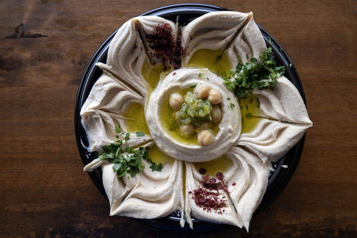 Hummus shaped like a star topped with chickpeas, cilantro, olive oil, and spices is served at Hummus and Pita on Tuesday, Sept. 2, 2025, in Overland Park.