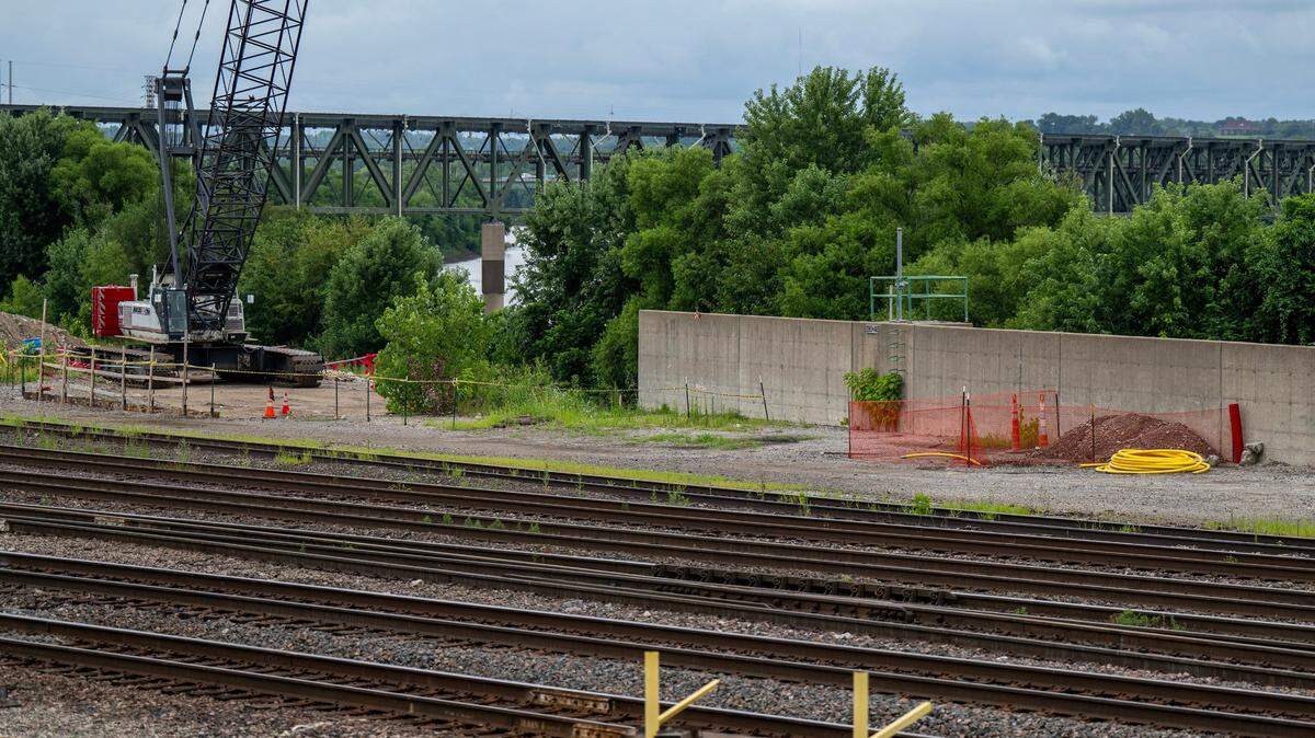 Hazard cones and caution tape surround construction equipment alongside a trench blocked off by orange netting near 16th Street and Metropolitan Avenue on Thursday, July 24, 2025, in Kansas City, Kansas.