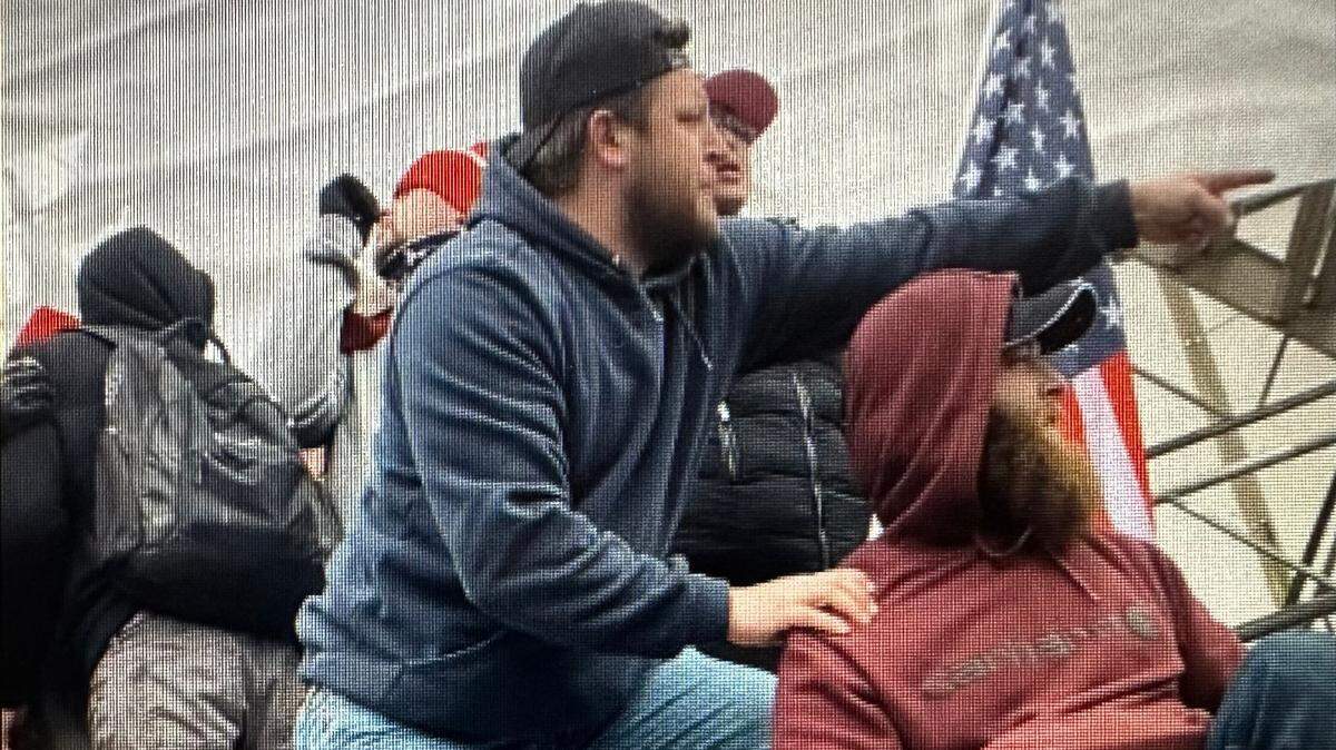 Eric Harrower, right, and Joshua Dressel used overturned bike racks as ladders to assist other rioters as they climbed the banister to the northwest steps of the Capitol on Jan. 6, 2021, prosecutors said. The mob eventually managed to break into the building.