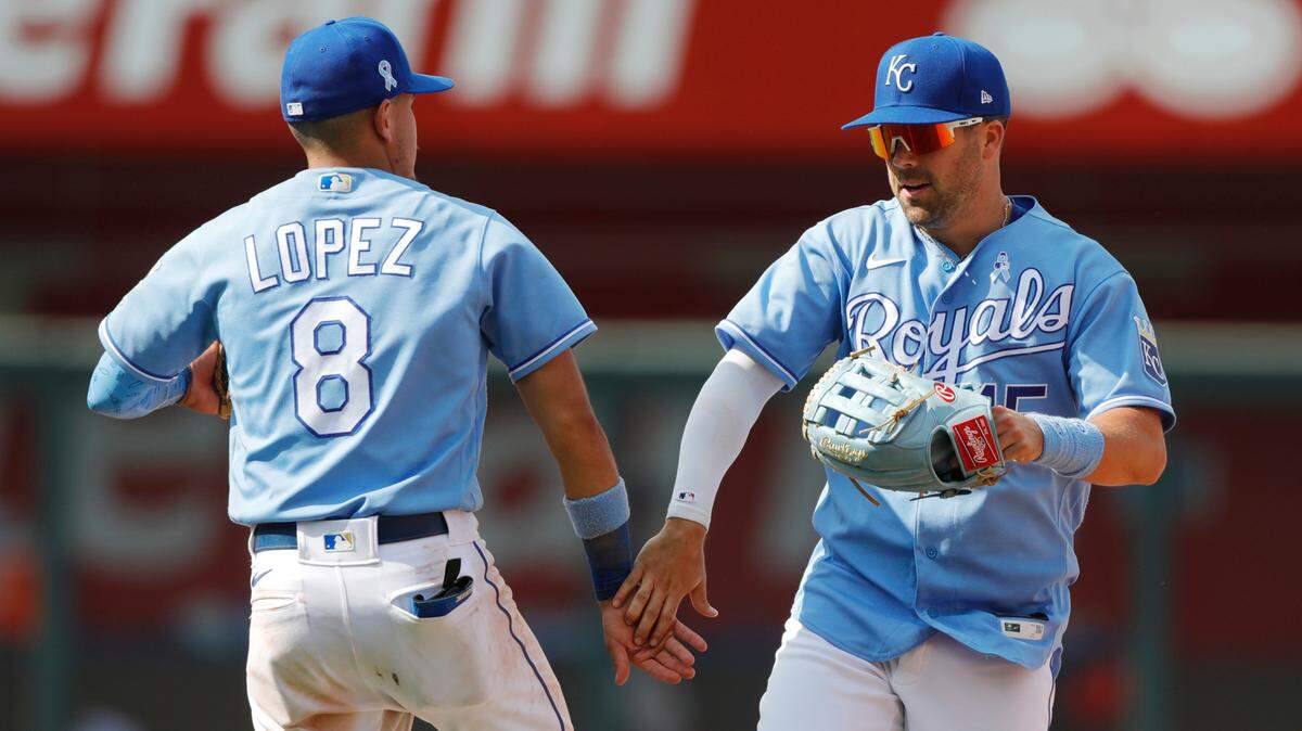 Kansas City Royals second baseman Nicky Lopez (8) and right fielder Whit Merrifield (15) celebrate their win over the Boston Red Sox in a baseball game at Kauffman Stadium in Kansas City, Mo., Sunday, June 20, 2021. (AP Photo/Colin E. Braley)