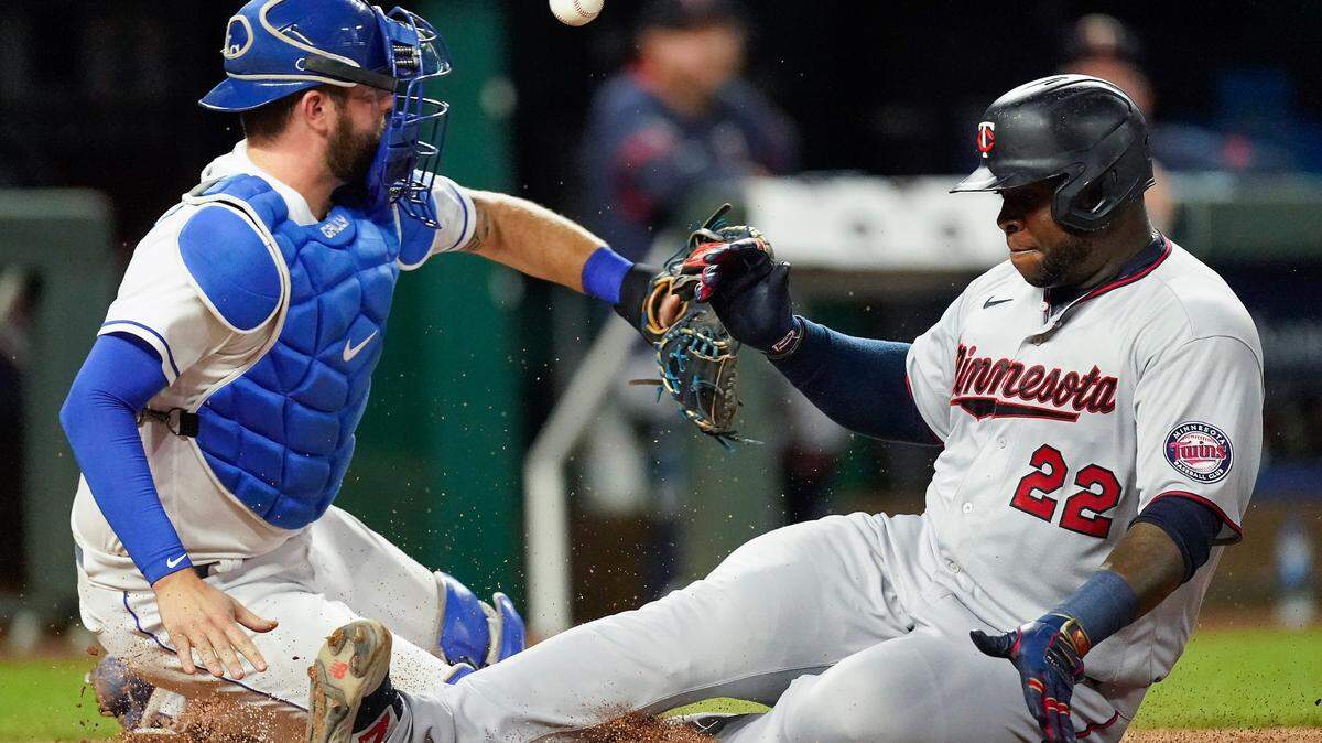 Minnesota Twins’ Miguel Sano (22) beats the tag by Kansas City Royals catcher Cam Gallagher to score on a sacrifice fly hit by Luis Arraez during the fourth inning of a baseball game Saturday, Oct. 2, 2021, in Kansas City, Mo. (AP Photo/Charlie Riedel)