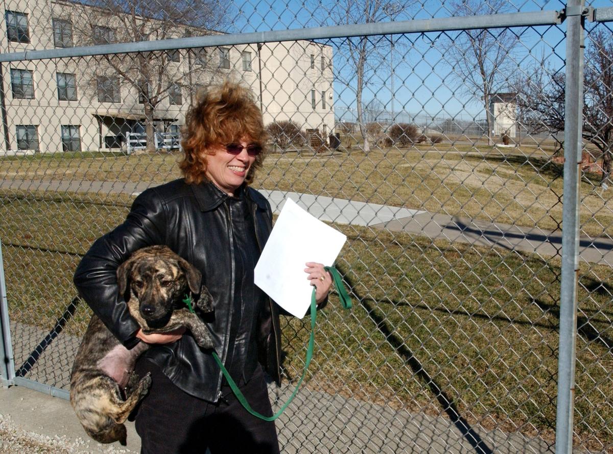 Toby Young carried a dog across the Lansing Correctional Facility grounds in January 2006.
