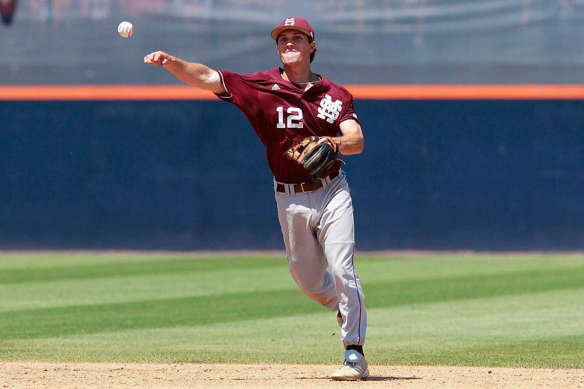 Mississippi State Bulldogs infielder Adam Frazier (12) throws to first base against the Virginia Cavaliers in the fifth inning during the Charlottesville Super Regional of the 2013 NCAA baseball tournament at Davenport Field on June 8, 2013.