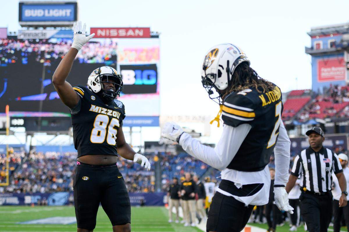 Missouri Tigers wide receiver Marquis Johnson (2) celebrates with tight end Jordon Harris (86) after his touchdown against the Iowa Hawkeyes during the first half at Nissan Stadium on Dec. 30, 2024.