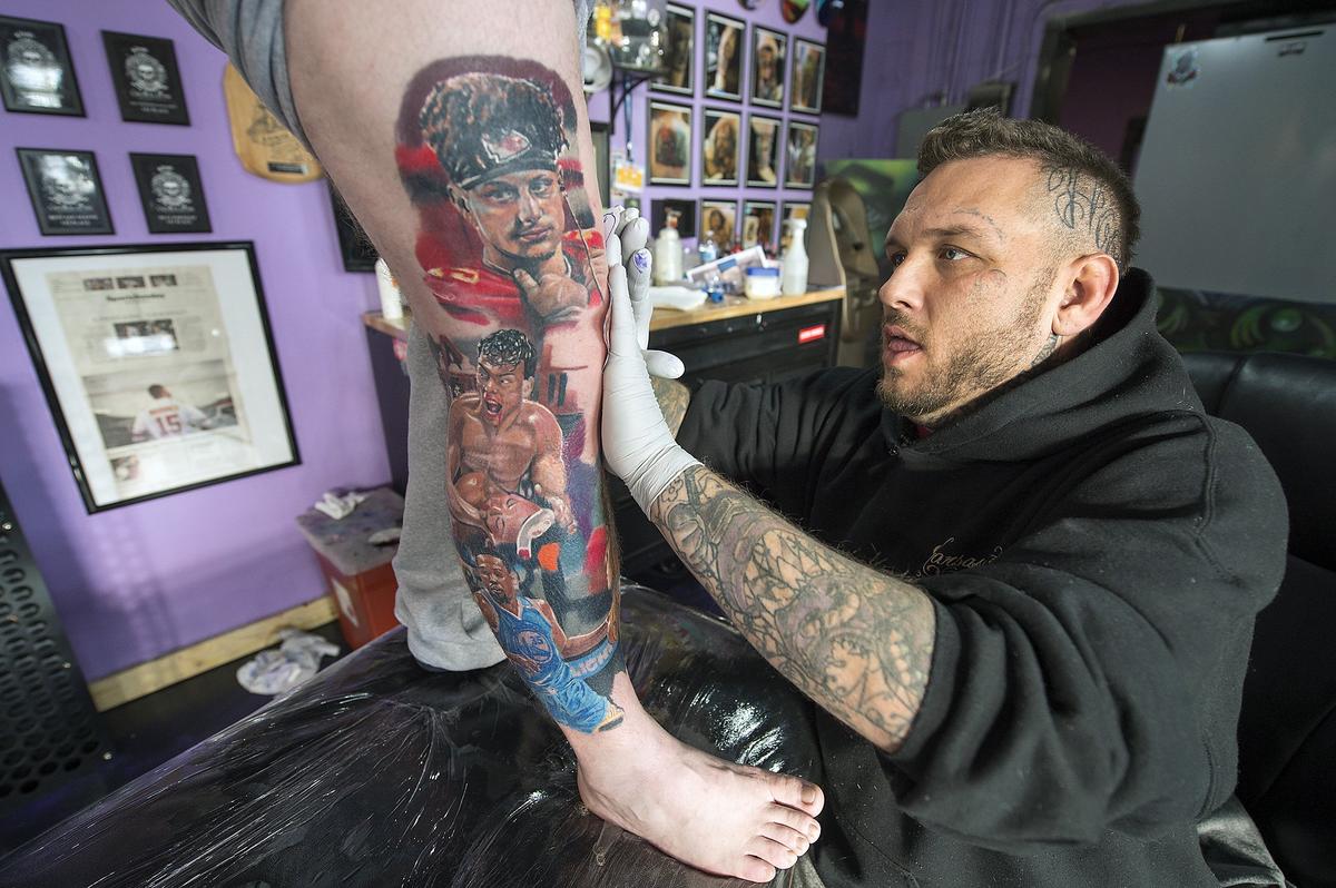 Tattoo artist Jeremy Taylor, owner of Skin Quest Tattoos, gets ready to ink another image onto Chiefs fan Rob Gaskins’ leg. Gaskins recently got a tattoo of tight end Travis Kelce and quarterback Patrick Mahomes. Planned is one of coach Andy Reid.
