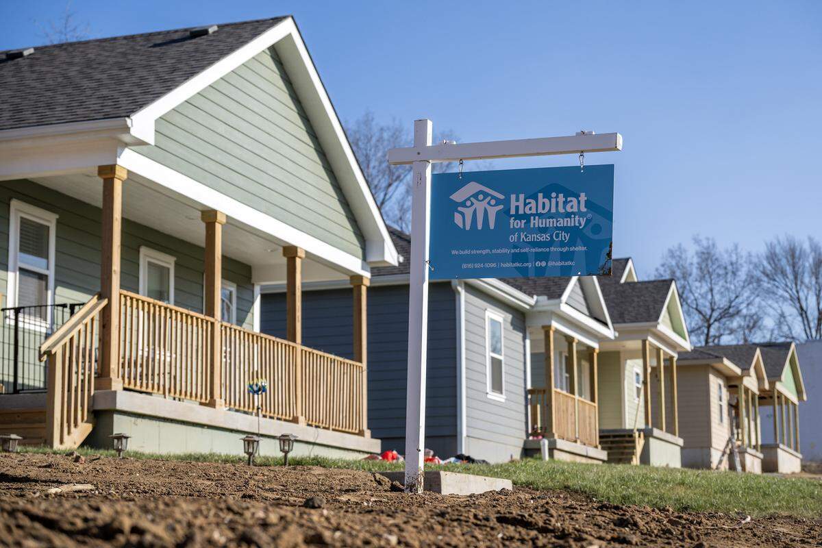 A Habitat for Humanity sign is displayed in front of newly built homes in Kansas City's Lykins neighborhood on Tuesday, Dec. 16, 2025.