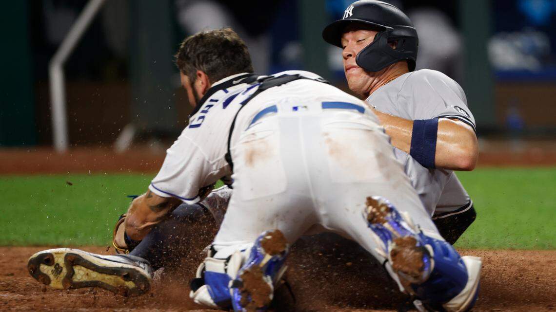 Kansas City Royals catcher Cam Gallagher, left, tags out New York Yankees’ Aaron Judge, right, at home plate after Judge attempted to score from third base on a hit in the seventh inning of a baseball game at Kauffman Stadium in Kansas City, Mo., Monday, Aug. 9, 2021. (AP Photo/Colin E. Braley)