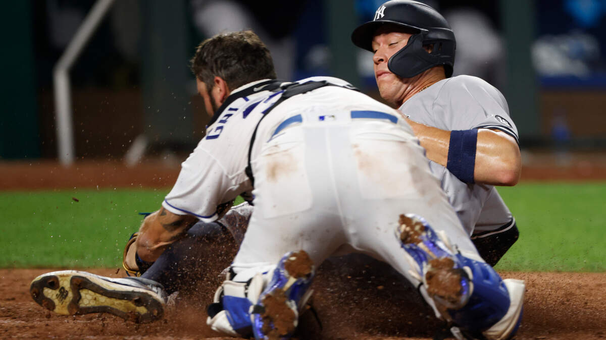 Kansas City Royals catcher Cam Gallagher, left, tags out New York Yankees’ Aaron Judge, right, at home plate after Judge attempted to score from third base on a hit in the seventh inning of a baseball game at Kauffman Stadium in Kansas City, Mo., Monday, Aug. 9, 2021. (AP Photo/Colin E. Braley)