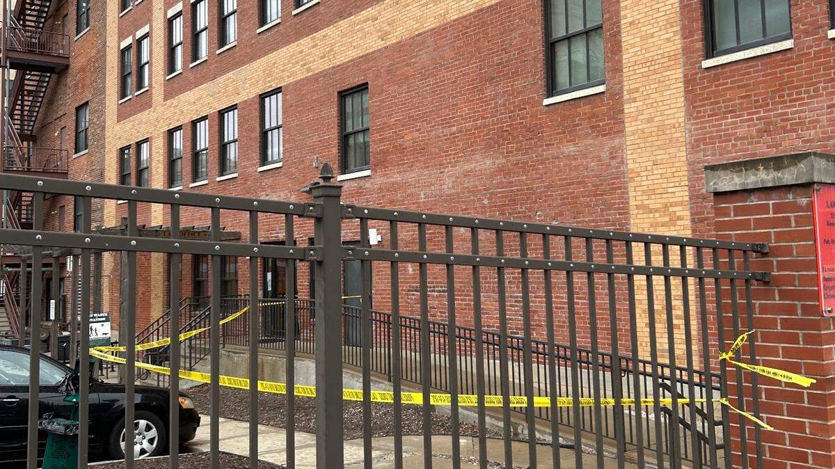 Police tape blocked off the back of an apartment building on 11th Street and Grand Boulevard Saturday morning after a shooting that left one man dead.