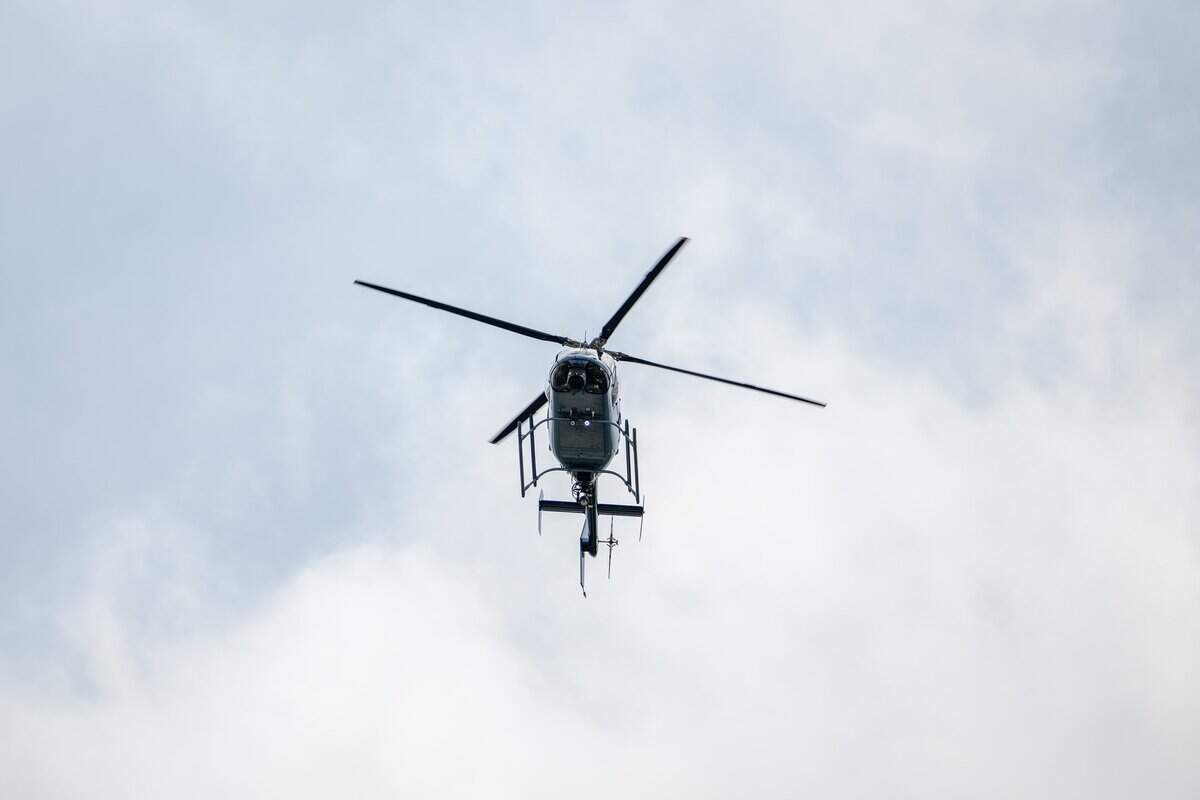 A helicopter is seen flying over Children's Mercy Park following the funeral service for Deputy Elijah Ming on Monday, Aug. 11, 2025.