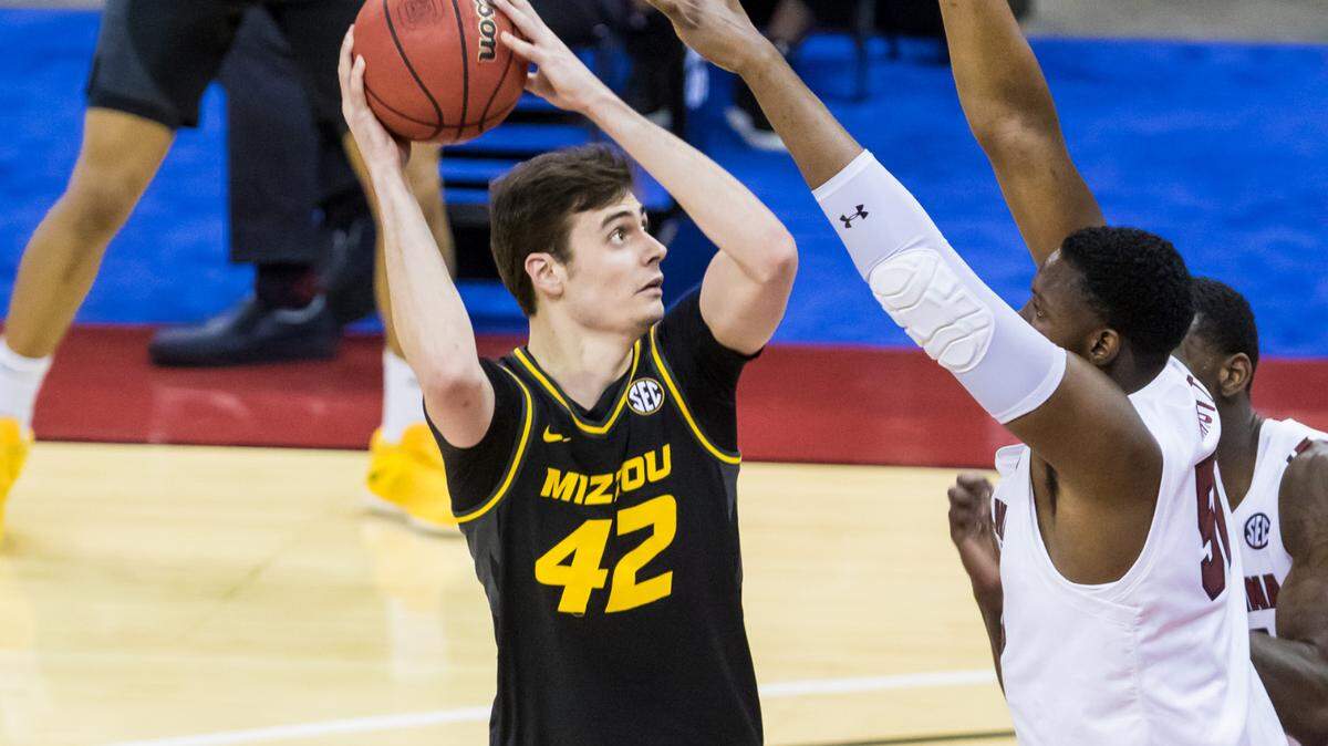 Missouri Tigers forward Parker Braun (42) looks to shoot over South Carolina Gamecocks center Tre-Vaughn Minott (50) in the first half at Colonial Life Arena in Columbia, South Carolina, on Feb 20, 2021.