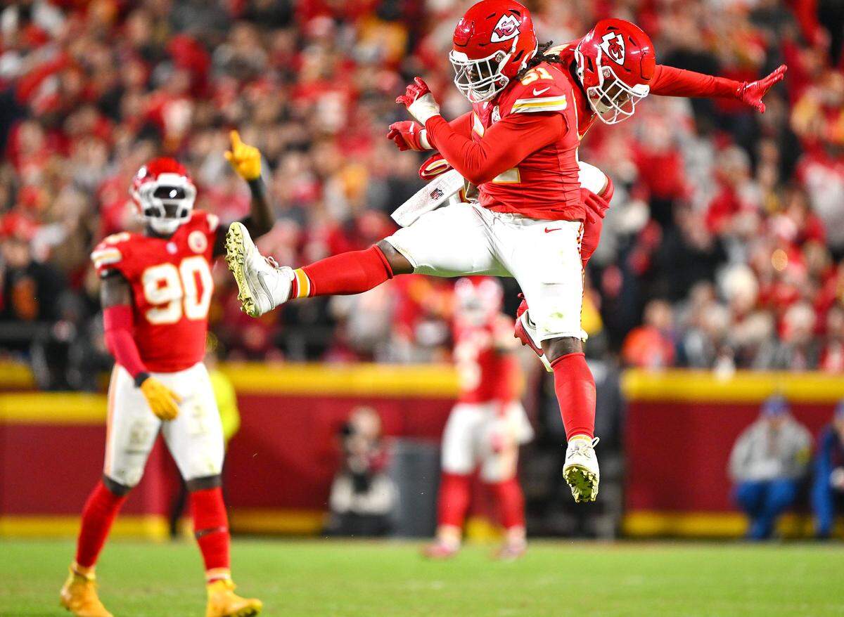 Kansas City Chiefs defensive end Mike Danna (51) and safety Jaden Hicks (21) bump each other in the air as they celebrated Danna's second half sack of Washington Commanders quarterback Marcus Mariota on Monday, Oct. 27, 2025, at GEHA Field at Arrowhead Stadium.