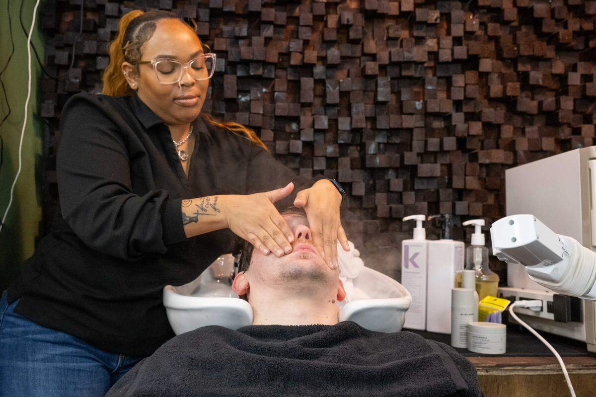 Barber Tehya Smith provides a facial to a client at Klassic Guy Barber Lounge on 9th, on Tuesday, February 3, 2026, in Kansas City. The barbershop and lounge offers facials, traditional barbering, and features a lounge area with a full service bar.