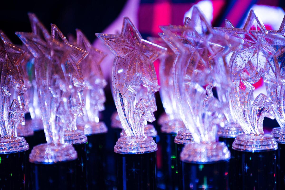 Trophies sit on a judging table before being handed to the winning Pride Ball contestants at the Uptown Theater on June 9, 2023, in Kansas City. After each performance category finished, judges handed out trophies and cash prizes to the winners.