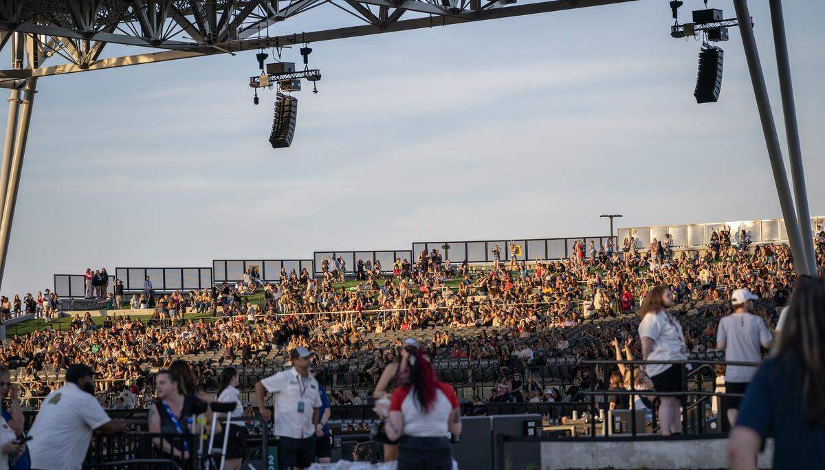 People gather on the lawn as the evening sun illuminates the Morton Amphitheater before Kesha's Freedom Tour concert on Wednesday, June 3, 2026, in Riverside.