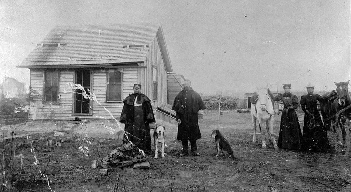 This undated photos shows the occupants of an early homestead in Nicodemus, Kansas.