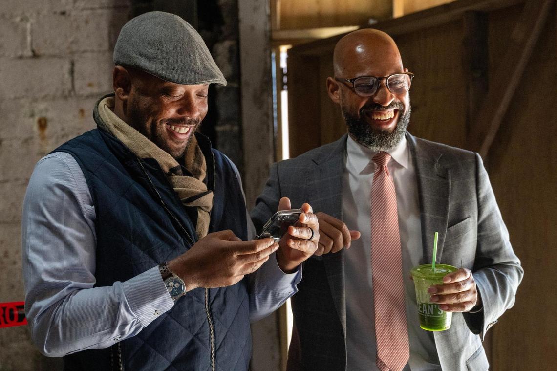 Shomari Benton, left, and Jason Parson laugh during an interview inside Boone Theater on Tuesday, Oct. 15, 2024, in Kansas City.