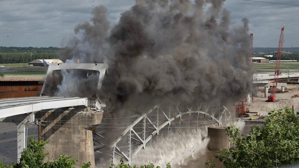 Explosive charges are detonated to take down the final arch of the Buck O’Neil Bridge Tuesday over the Missouri River near downtown Kansas City.