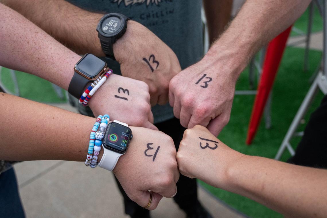 Swifties show off Taylor Swift’s lucky number drawn on the backs of their hands Saturday during Kansas Swiftie Monarchs night at Legends Field.