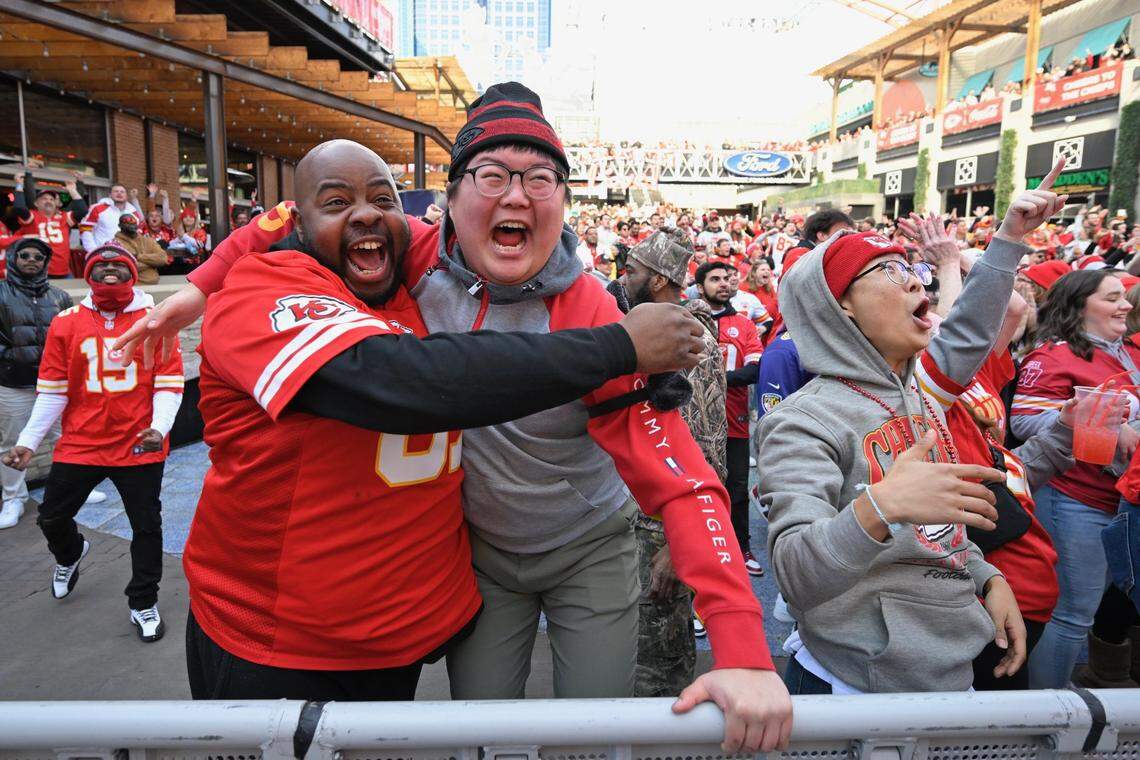 Jimmie Clark of East St. Louis, Andrew Kang of Kansas City and his brother, Joonyoung Yang, right, who flew in from South Korea for the Chiefs’ AFC Championship Game against the Baltimore Ravens in 2024, celebrate a touchdown at the Power & Light District on Sunday, Jan. 27, 2024.