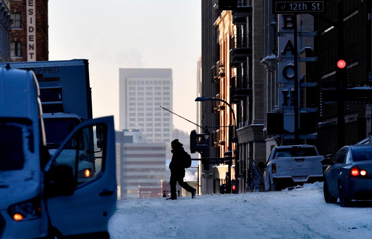 With wind chills dipping well below zero Tuesday morning, pedestrians navigated the frozen streets of downtown Kansas City, near 12th and Baltimore. Wind chills were expected to be below zero again Tuesday night and the forecast for Wednesday called for cloudy skies and a high of 20.