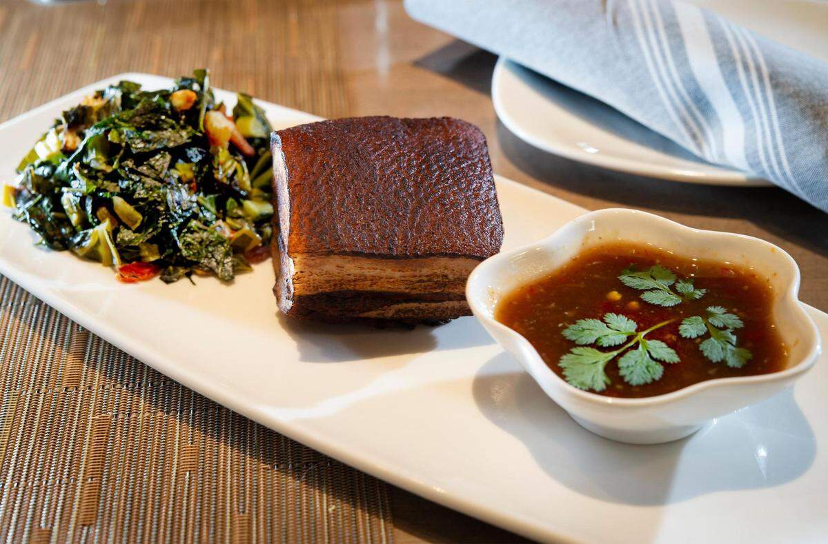 Seared pork belly and collard greens at Bamboo Penny’s.