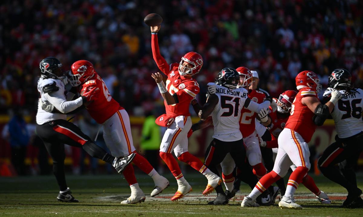 The Kansas City Chiefs offensive line holds off defensive pressure from the Houston Texans while Kansas City Chiefs quarterback Patrick Mahomes (15) throws a pass in the second quarter on Saturday, Dec. 21, 2024, at GEHA Field at Arrowhead Stadium.