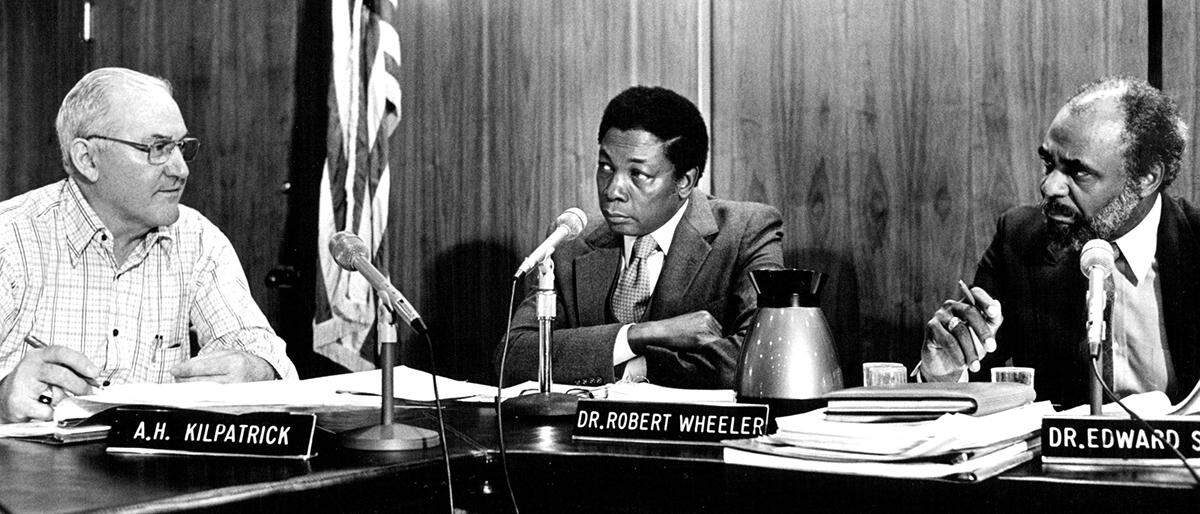 Kansas City Board of Education President Edward W. Scaggs (right) and Superintendent of Schools Robert R. Wheeler (center) listen to board member A.H. Kilpatrick’s comments on the district’s preliminary 1981-82 operating budget Monday night.