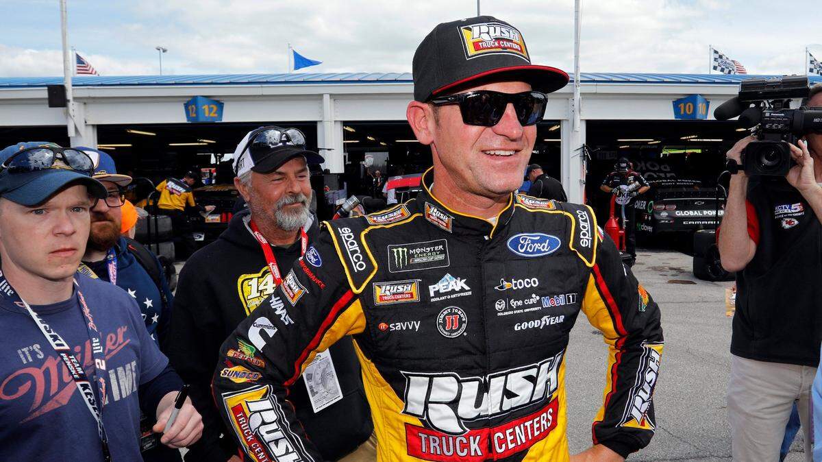 Driver Clint Bowyer stands in the garage area during practice for the NASCAR Cup Series auto race at Kansas Speedway in Kansas City, Kan., Friday, May 10, 2019. (AP Photo/Colin E. Braley)
