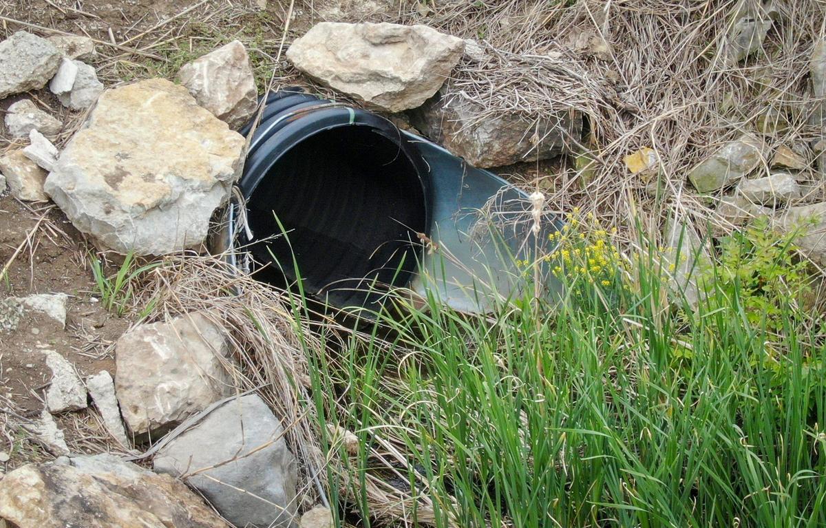 A small storm water drain near the home of Max Cook, who lives in the College Meadows neighborhood, is too small to handle the storm water runoff.