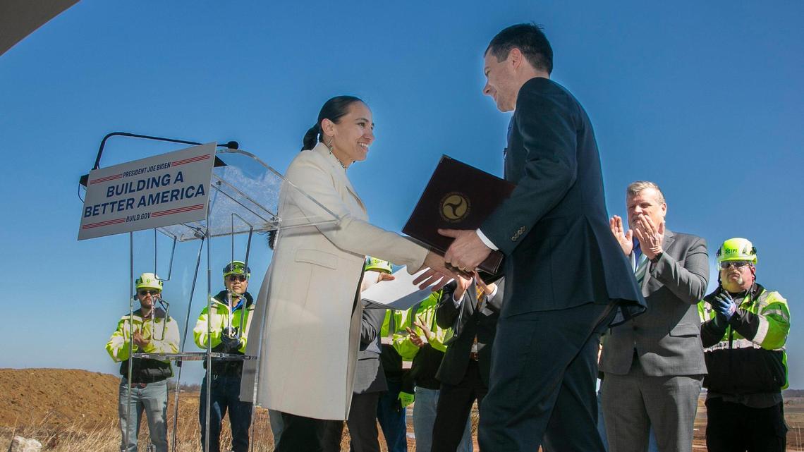 Transportation Secretary Pete Buttigieg greeted U.S. Rep. Sharice Davids, D-Kansas, during a press conference and visit to the Panasonic site in De Soto on Monday.